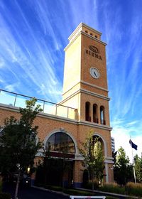 Low angle view of clock tower against cloudy sky