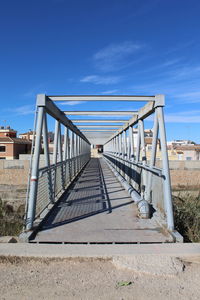 Footbridge against sky