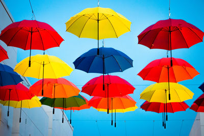 Multi colored umbrella against blue sky