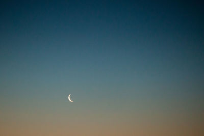 Low angle view of moon against clear sky at night