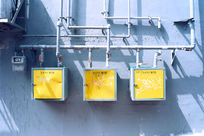 Yellow boxes with pipes on wall
