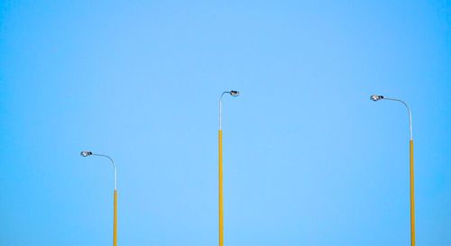 Low angle view of street light against clear blue sky