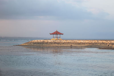 Lifeguard hut on beach against sky