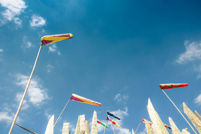 Low angle view of flag windsocks against sky