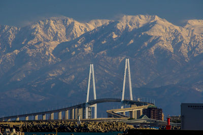 Shinminato ohashi bridge and the snow-capped tateyama mountain range