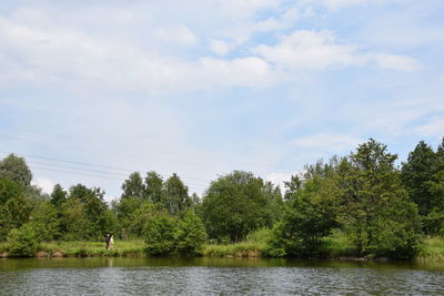 Scenic view of scenery and trees against sky