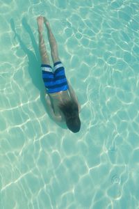 Directly above shot of shirtless man in swimming pool