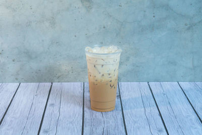 Close-up of coffee on table against wall