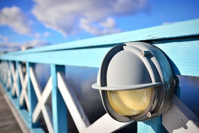 Close-up of railing against blue sky