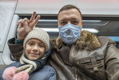 Portrait of father with daughter in train