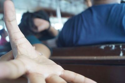 Midsection of couple holding hands