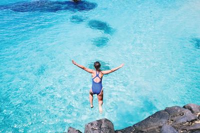 High angle view of woman swimming in sea