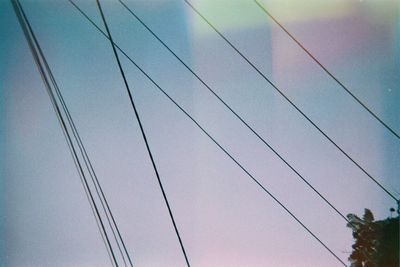 Low angle view of power lines against sky