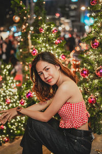 Full length of woman with christmas tree