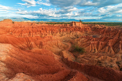 Scenic view of rock formations against cloudy sky at tatacoa desert