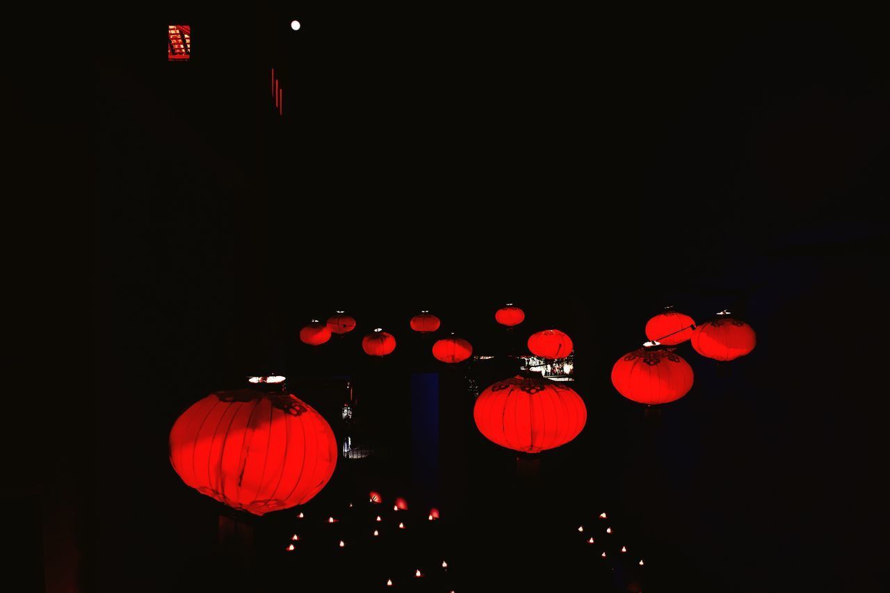 LOW ANGLE VIEW OF LANTERN HANGING AT NIGHT