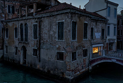 Abandoned building by canal