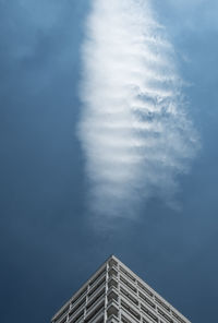 Low angle view of modern building against blue sky