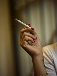 Midsection of woman holding cigarette