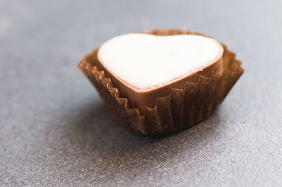 Close-up of heart shape chocolate on fabric