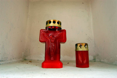 Close-up of fire hydrant on table against wall