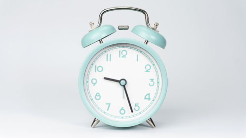 Close-up of clock on white background