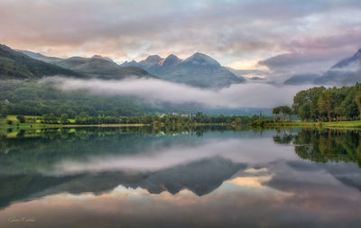 Scenic view of lake and mountains against sky