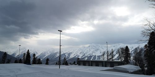 Scenic view of snow covered mountains against sky