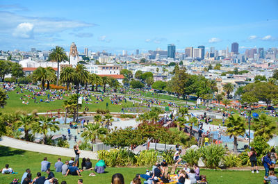 Crowd at mission dolores park against sky