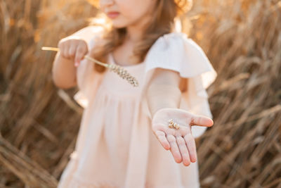 Midsection of young woman holding hands