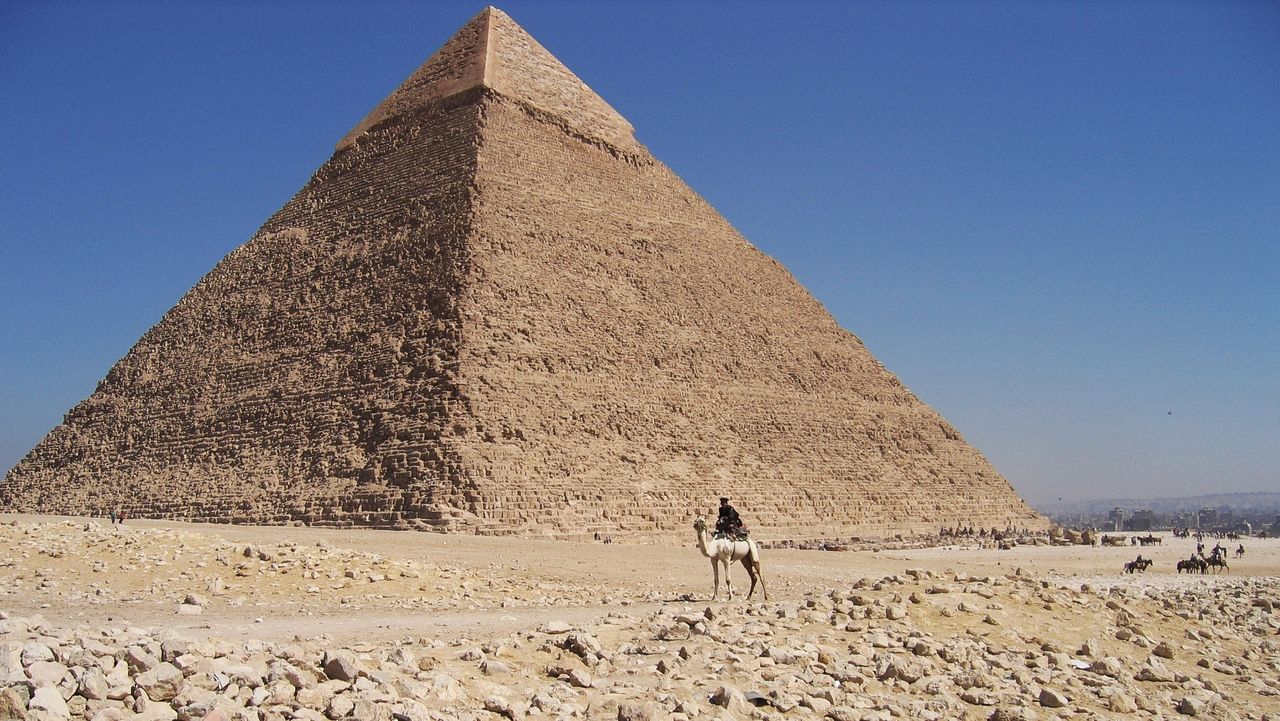 VIEW OF A HORSE ON DESERT AGAINST SKY