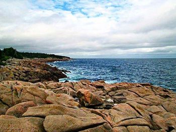 Scenic view of sea against cloudy sky