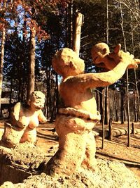 Statues on tree trunk