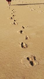 High angle view of footprints on sand at beach