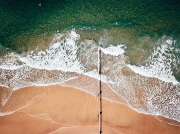 High angle view of sea waves splashing on shore