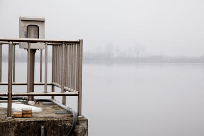 Observation point on riverbank during foggy weather
