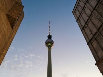 Low angle view of communications tower against sky