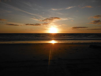 Scenic view of beach against sky during sunset