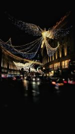 Defocused image of illuminated city against sky at night