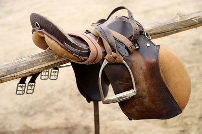 Close-up of shoes hanging on wood