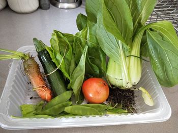 High angle view of fruits and leaves on table