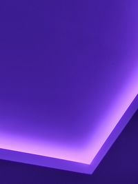 Low angle view of illuminated ceiling against clear blue sky