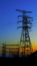 Low angle view of electricity pylon against sky