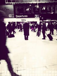 People walking on railroad station platform