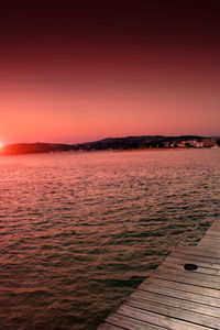 Scenic view of sea against clear sky during sunset