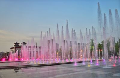 Panoramic view of fountain in city against clear sky