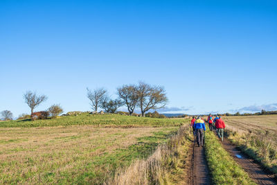 Group with people walking on a dirt road