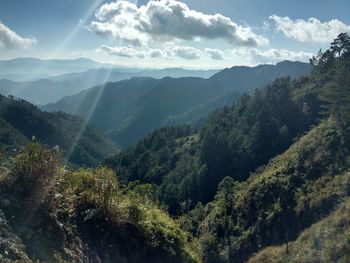 Scenic view of mountains against cloudy sky