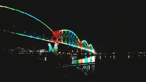 Illuminated ferris wheel at night