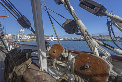 Sailboats moored at harbor against clear sky